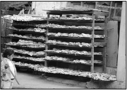 A bakery displays loaves of bread on racks. Cory Langley