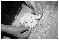 Making soft pretzels. Twist the ropes into pretzel shapes and place them on a greased cookie sheet. EPD Photos