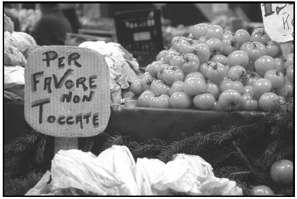 To protect his produce from too much handling, this vendor displays a sign reading "Please don't touch" in Italian. Per favore is "please." Cory Langley