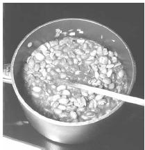 Frijoles are simmered over low heat until most the liquid has been absorbed and the beans and onion are soft. EPD Photos