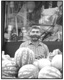 A colorful Turkish fruit vendor poses with his melons. Cory Langley