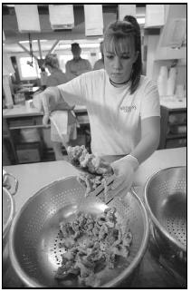 An employee at Woodman's restaurant in Essex, Massachusetts, scoops fried clams into a box. Woodman's is believed to be the first place to serve fried clams. People in the Northeast enjoy clams in many forms—steamed, fried, and in chowders. AP Photo/Josh Reynolds